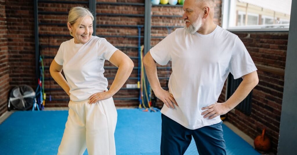 Elderly couple in white shirts having fun exercising indoors for fitness and wellness.